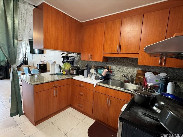 kitchen featuring sink, light tile patterned floors, black range with electric cooktop, and decorative backsplash