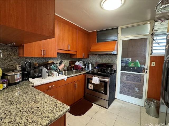 kitchen featuring sink, decorative backsplash, stainless steel appliances, and wall chimney exhaust hood