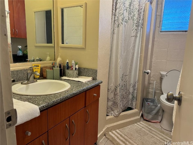 bathroom featuring vanity, curtained shower, and toilet