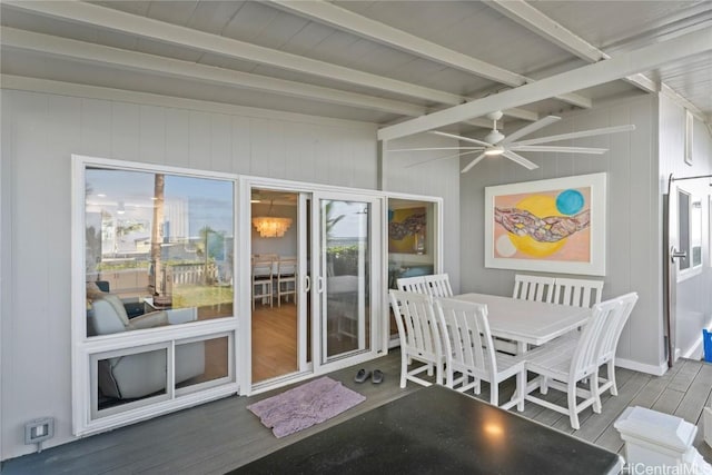 sunroom with ceiling fan and lofted ceiling with beams