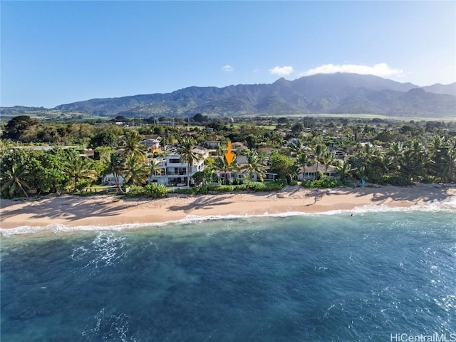 birds eye view of property featuring a water and mountain view and a view of the beach