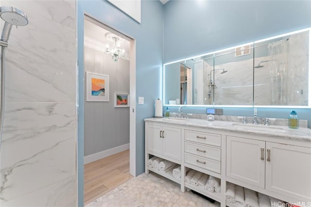 bathroom featuring hardwood / wood-style flooring, vanity, and a tile shower