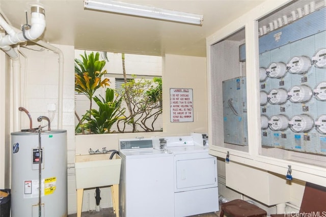 laundry area featuring water heater, washer and dryer, and sink