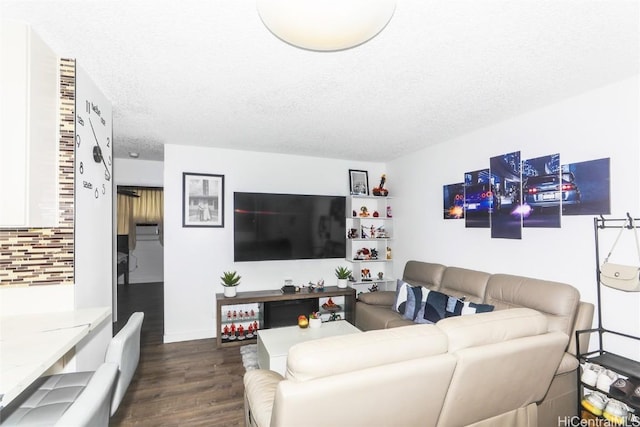 living room with dark hardwood / wood-style floors and a textured ceiling