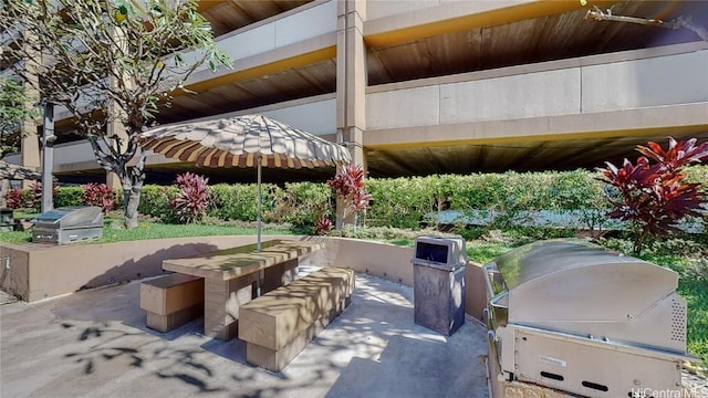 view of patio featuring area for grilling and a grill