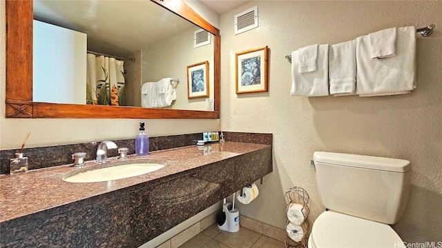 bathroom with sink, tile patterned floors, and toilet