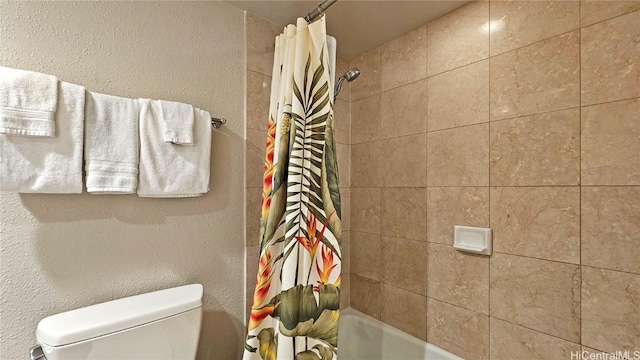 bathroom with toilet and shower / bath combo with shower curtain