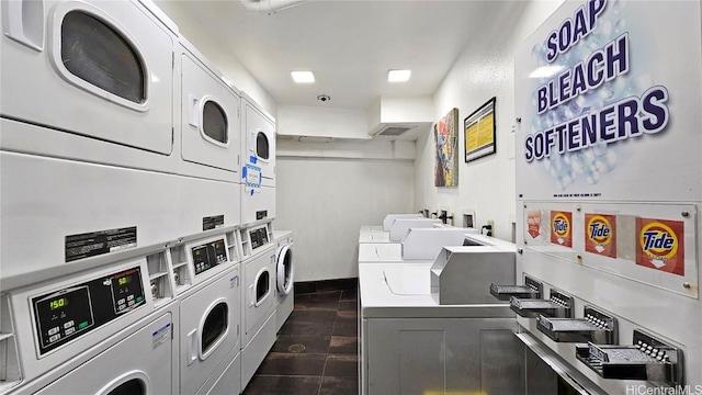 washroom with stacked washer and clothes dryer and washing machine and clothes dryer