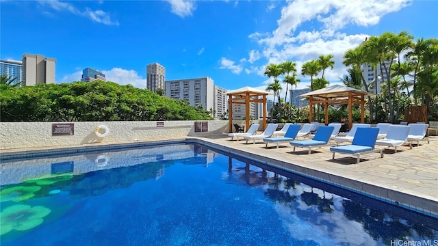 view of swimming pool with a gazebo and a patio