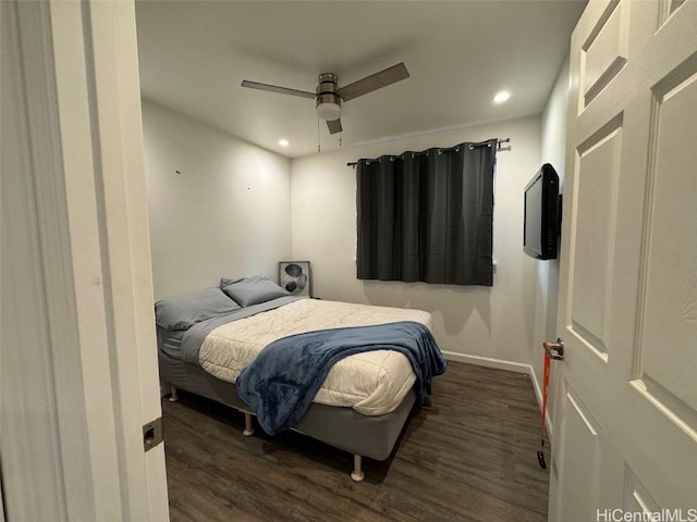 bedroom with ceiling fan and dark hardwood / wood-style floors