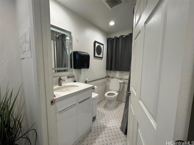 bathroom featuring vanity, toilet, and tile patterned flooring