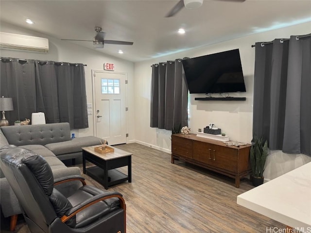 living room featuring hardwood / wood-style flooring, ceiling fan, a wall mounted air conditioner, and vaulted ceiling