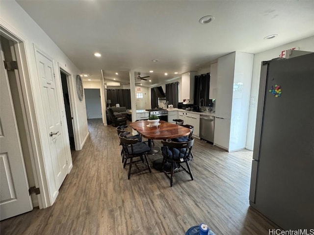 dining room with ceiling fan and light wood-type flooring