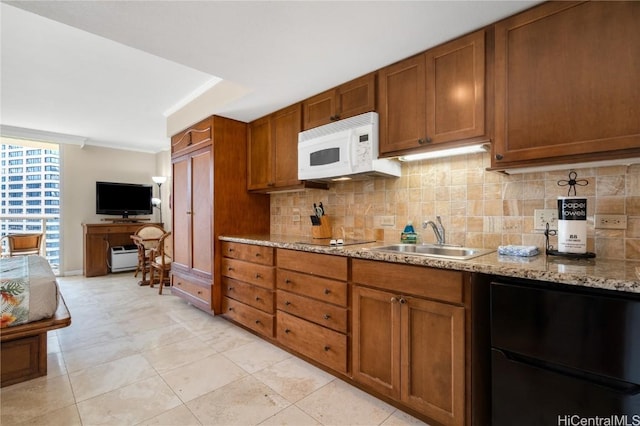 kitchen with sink, backsplash, ornamental molding, black electric stovetop, and light stone counters