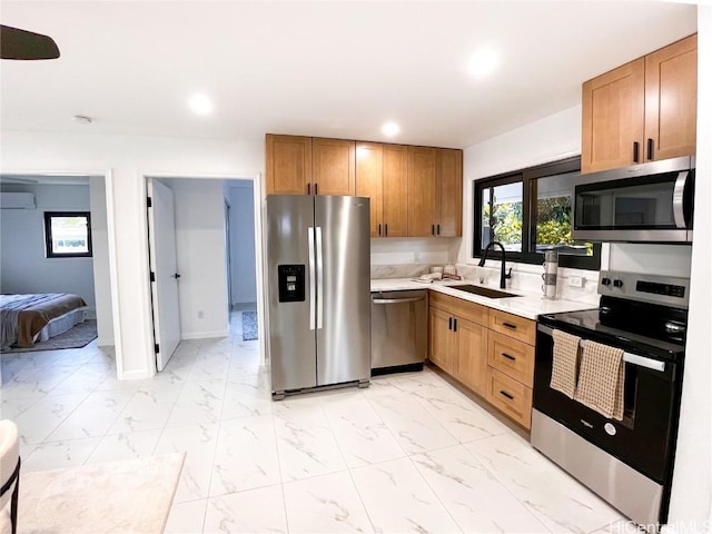 kitchen featuring stainless steel appliances, sink, and a wall mounted air conditioner