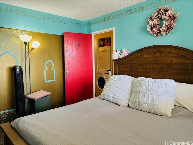 bedroom with stacked washer and dryer and a textured ceiling