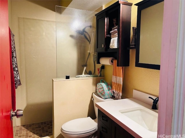 bathroom featuring vanity, toilet, and walk in shower