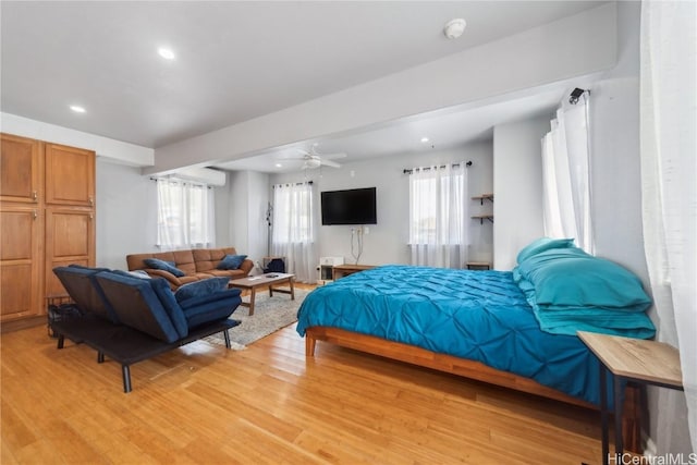 bedroom with ceiling fan and light hardwood / wood-style floors