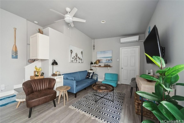 living room featuring ceiling fan, a wall mounted AC, and light wood-type flooring