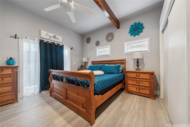 bedroom featuring beamed ceiling, ceiling fan, and light hardwood / wood-style flooring