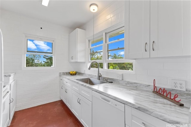 kitchen with white dishwasher, sink, and white cabinetry