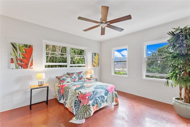 bedroom featuring ceiling fan and concrete flooring