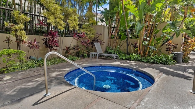 view of swimming pool with a patio area and an in ground hot tub