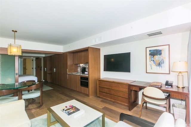 2139 Kuhio Ave Unit 1810, Honolulu, HI 96815 - living area featuring dark wood finished floors and an office area