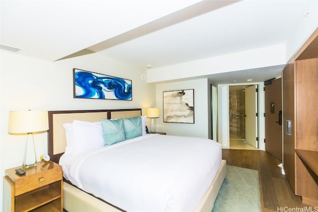 2139 Kuhio Ave Unit 1810, Honolulu, HI 96815 - bedroom with dark wood-style floors and ensuite bath
