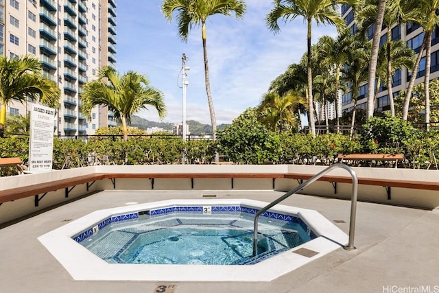 view of swimming pool with a community hot tub