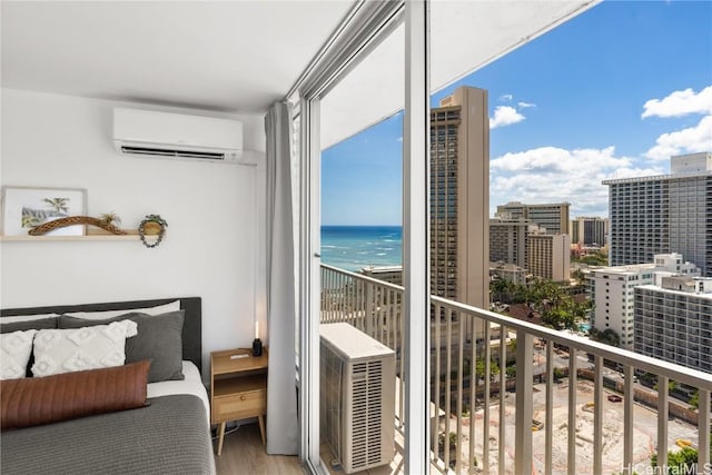 balcony featuring a water view, cooling unit, and an AC wall unit