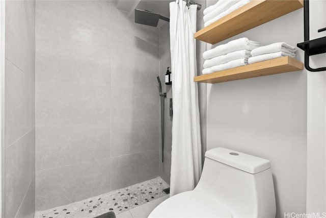 bathroom with toilet and a shower with shower curtain