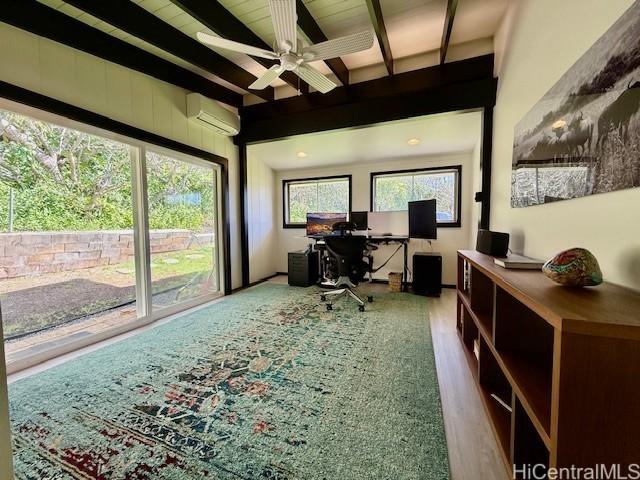 office space featuring ceiling fan, a wall mounted air conditioner, and beam ceiling