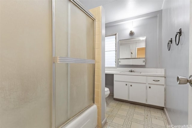 full bathroom featuring toilet, vanity, and bath / shower combo with glass door