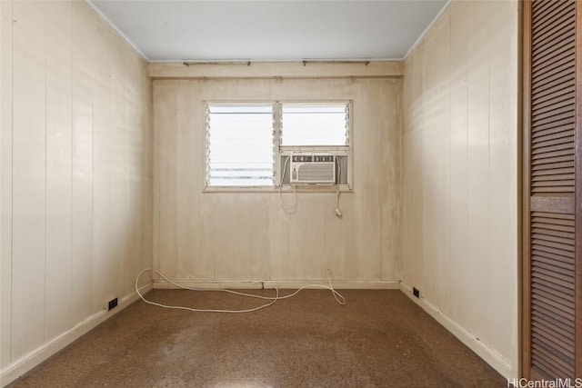 empty room with cooling unit and dark colored carpet