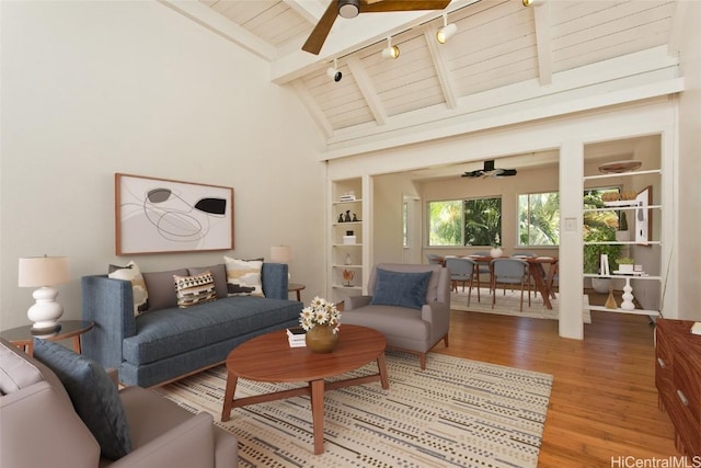 living room featuring ceiling fan, beam ceiling, hardwood / wood-style floors, and wooden ceiling