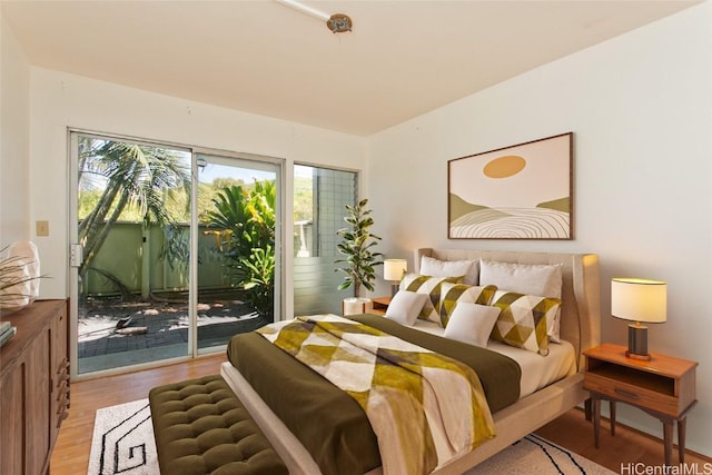 bedroom featuring access to exterior and light hardwood / wood-style flooring