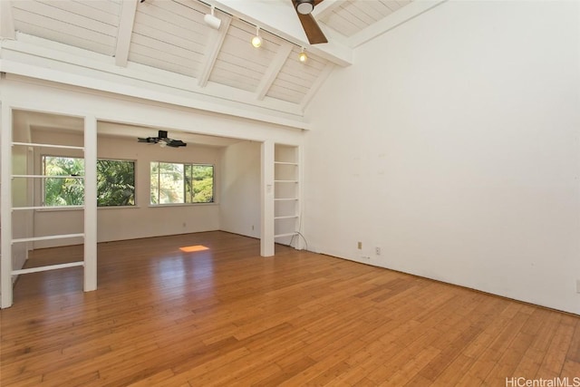 unfurnished living room with wood-type flooring, wooden ceiling, beamed ceiling, and ceiling fan