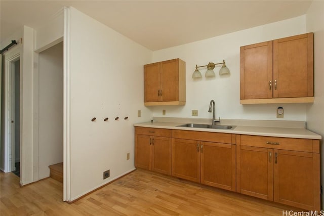 kitchen featuring sink and light wood-type flooring