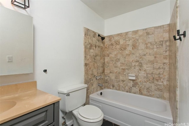 full bathroom with vanity, tiled shower / bath combo, and toilet