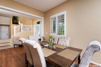 dining area with dark wood-type flooring