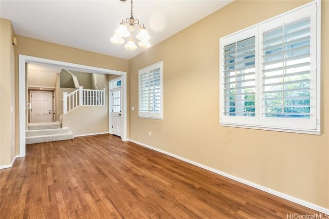 interior space with a notable chandelier and hardwood / wood-style flooring