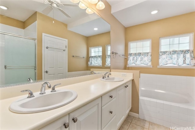 bathroom featuring a relaxing tiled tub, ceiling fan, vanity, and tile patterned flooring