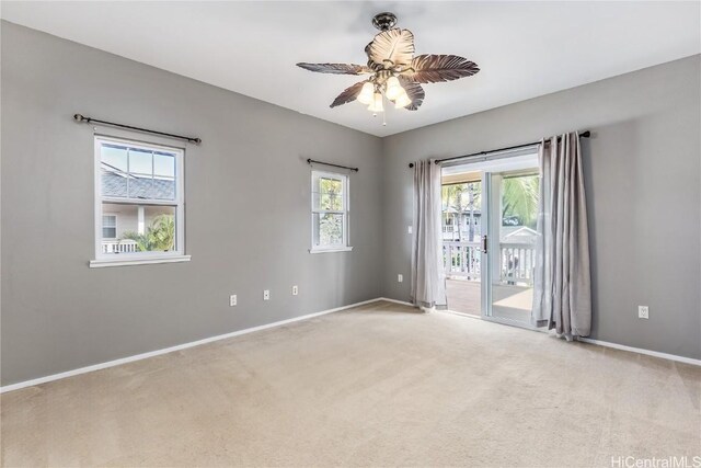 empty room featuring light colored carpet and ceiling fan