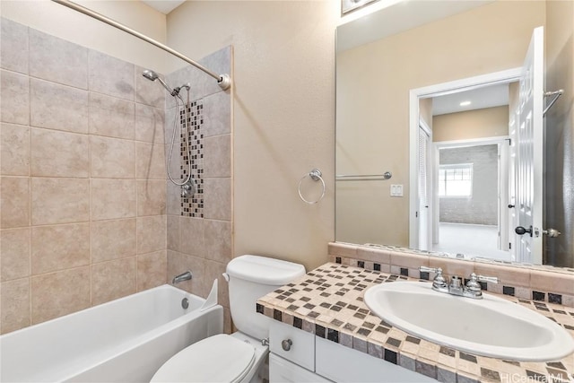 full bathroom with vanity, toilet, and tiled shower / bath combo