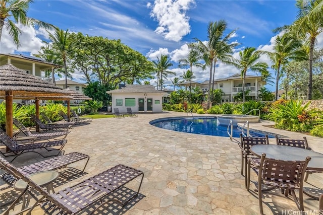 view of pool with a gazebo, an outbuilding, and a patio area