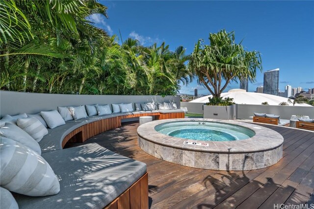 view of pool featuring an outdoor hot tub, outdoor lounge area, and a deck