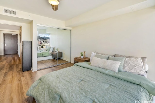 bedroom with hardwood / wood-style floors and a closet