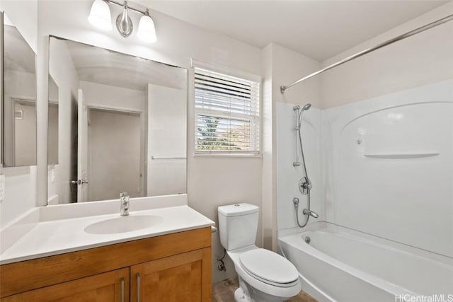 full bathroom featuring vanity, bathtub / shower combination, and toilet