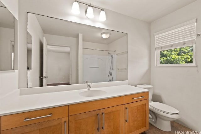 bathroom with vanity, toilet, and walk in shower